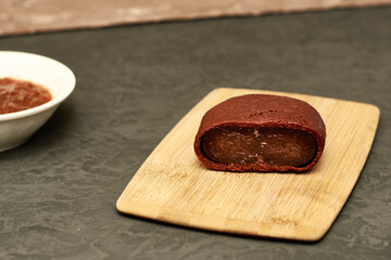 basturma on a wooden cutting board next to a plate with spices