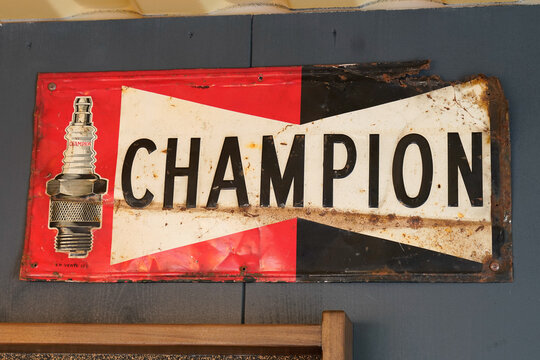 champion spark plugs logo brand and text sign on old rusty panel racing vintage car for race vehicle