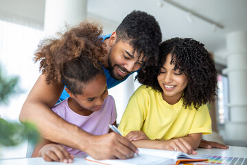Front view of African American parents helping their daughter with homework at table,