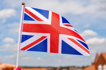 The national union jack flag of Great britain red white and blue colors