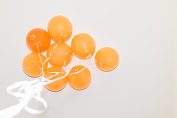 Bunch orange balloons on white background.Bottom view.