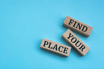 On a bright blue background, light wooden blocks with the text Find Your Place.