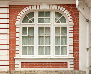Window in the wall of a brick house.