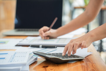 Fototapeta premium Close up of woman planning home budget and using a calculator.