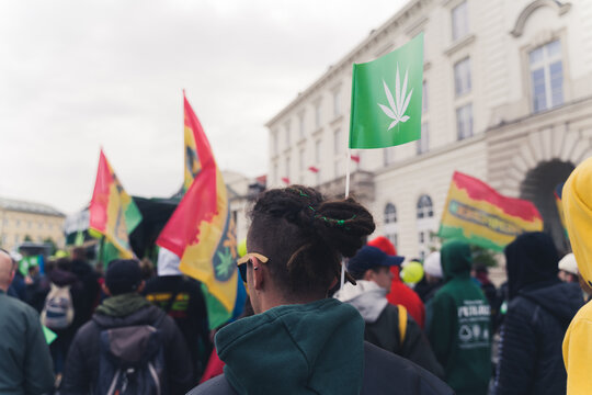 Pro-cannabis March. Protester go against the government law and fight for their right to smoke recreational weed. Red-yellow-green flags and little flags with marijuana leaf. High quality photo