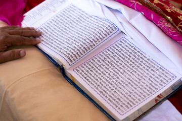Guru Granth Sahib Holy Religious Scripture of Sikhism. Punjabi language written on religious white...