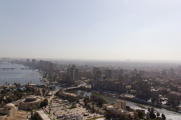 Ariel view of Cairo Egypt, a sprawling concrete megacity with Pyramids in the distance