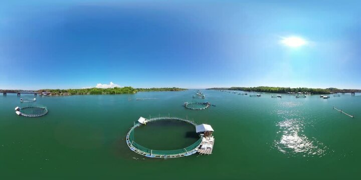 Fish farm with cages for fish and shrimp. 360VR. Fish ponds for bangus, milkfish. Farming aquaculture or pisciculture practices. Philippines, Luzon.