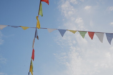 Festive colorful flags in the blue sky