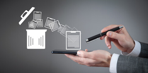 Man using smartphone. Trash can and files. Delete files