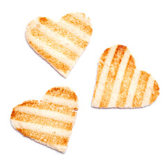 Toasted heart shaped bread with grill marks isolated on white background