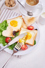 Fried Egg on Toast Bread and cup of fresh hot coffee on light grey background