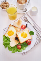 Fried Egg on Toast Bread and cup of fresh hot coffee on light grey background