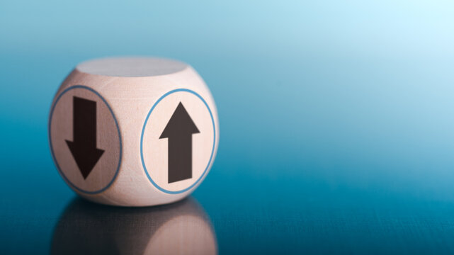 arrow pointing up and down on wooden cube block,economic growth and investment concept Analysis trend and strategy growth direction through different and better alternative change.