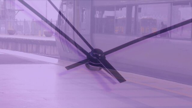 Composite video of close up of a ticking clock against train halted at a train station