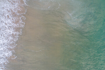 zenithal aerial view of the shore of a beach with turquoise waters