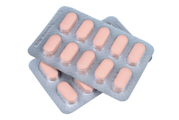 Pink pills in a blister pack on a white background