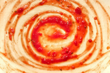 The process of cooking pizza. Circles of tomato paste on the rolled out dough