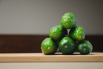 Fresh cucumbers on a wooden cutting board. Vegetables on the kitchen table