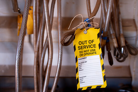 Safe workplaces practices yellow out of service warning tag sign placing on damaged faulty unsafe to use industrial fall arrest structural industrial hard link 25 KN rope access anchor point