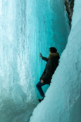 
Winter Scenery: Images from inside the frozen waterfall. It forms a beautiful ice cave, with flowing water and ice stalactites and stalagmites. Sharp details: clear and transparent ice.