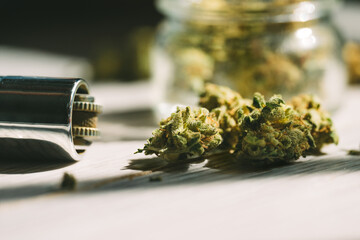 Close up of medical marijuana or cannabis flower buds and lighter.