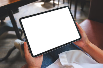Top view mockup image of a woman holding digital tablet with blank white desktop screen