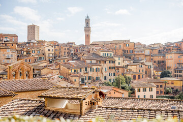 Obraz premium Cityscape of Siena town with bell tower of town hall in Tuscany region of Italy. Concept of visiting italian landmarks