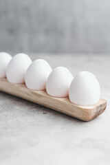 Eggs yolk white raw on grey background