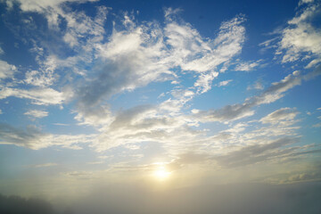 Unfocused Landscape Sunset behind the cloud or misty clover on cloudy day - abstract background nature scene from chiang rai thailand 