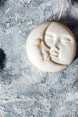 Candle in the shape of the moon. Lunar decor