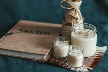Scented candles in the interior. Interior details in milk colors. Combination of blue and beige....