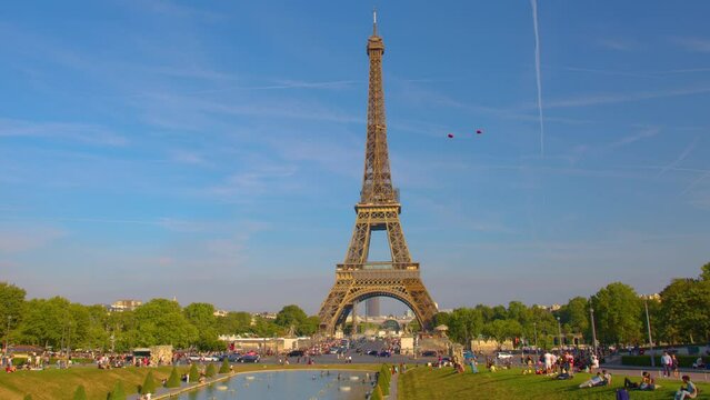Most popular tourist landmark in France. Traffic on road. Paris, France. Sunny evening Paris city riverside famous tower