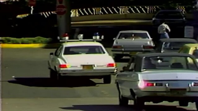 1978 POLICE CAR DRIVING IN PARKING LOT