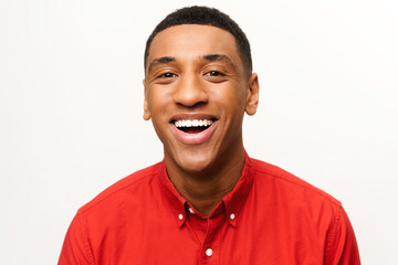 Portrait of happy satisfied handsome young man in shirt standing and looking at the camera with...