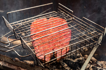 Cooking outside a seasoned denver steak meat on the grill, barbeque