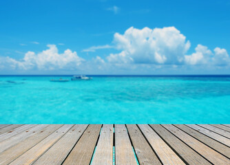 Empty top of wood table with turquoise seascape of Maldives, ready for product display montage, summer vacation background concept