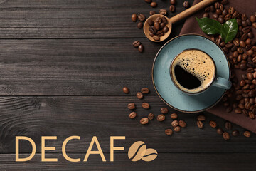 Cup of aromatic decaf coffee and beans on black wooden table, flat lay - obrazy, fototapety, plakaty