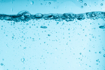 blue splash of water in a glass vessel. clean clear water