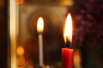 Red burning candle in church, closeup. Space for text