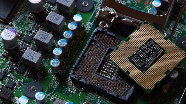 Detail of a CPU Processor over his Socket on a Motherboard. Printed Circuit Board - Computer Motherboard with Components. Shot with Rotation Movement