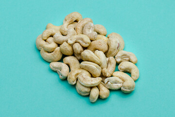 100 grams of cashews on a green background
