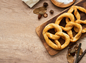 top view or flat lay group of pretzel in wood plate on wooden table background.                                                 