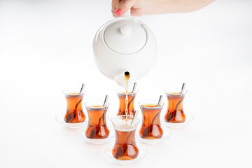 six piece tea cups 6 saucers and 6 tea spoons porcelain red nail polish female hand pouring tea...