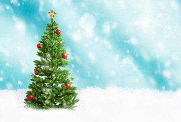 Fototapeta na wymiar Christmas tree on a blue background with falling snow