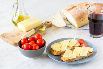 Olive-fried bread with cheese and tomato