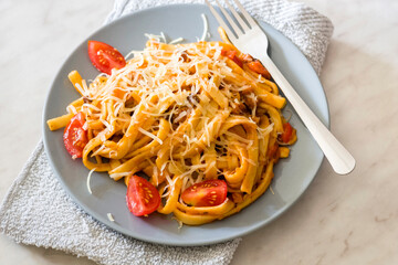 Tagliatelle pasta with tomato sauce and sausage