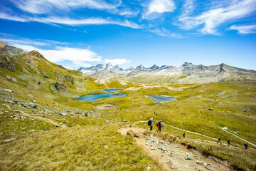 Excursion on the Gran Paradiso in the Alps. Walk in immense valleys and very high peaks above 3000m. Glacial lakes with crystal clear water and green meadows. The peaks crowned by huge rocks.