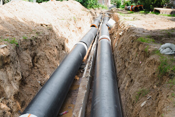 Plumbing repair. Installation of new industrial street water pipes in dug hole in two lines,...