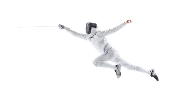 Dynamic portrait of young man, fencer in in fencing costume with sword in hand training isolated on white studio background. Sport, energy, skills
